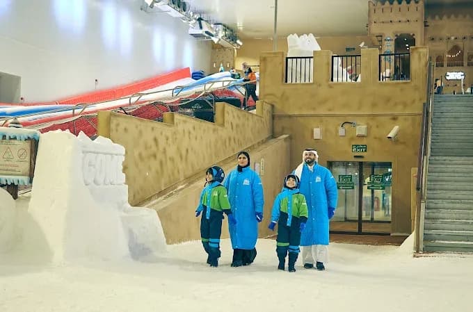 Family playing in the snow at Snow Dunes Qatar